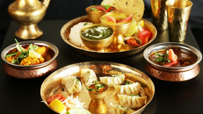 Momos (front) with aaloo kopi, thali set, and morang khasi at Hamro Aangan. Picture: Braden Fastier