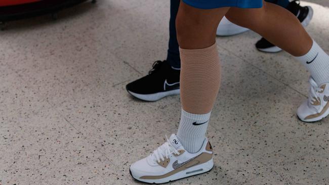 Sam Kerr’s calf was heavily bandaged at Sydney airport Picture: David Swift