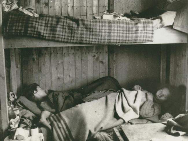 Two women laying in a bunk in the Bergen-Belsen Concentration Camp. Living conditions were cramped. Picture: Sydney Jewish Museum Collection