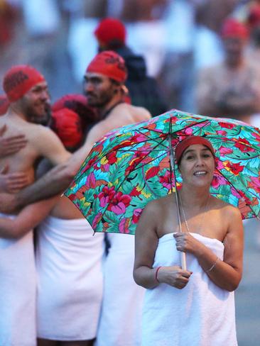 Keeping dry before the start of the swim. Picture: NIKKI DAVIS-JONES