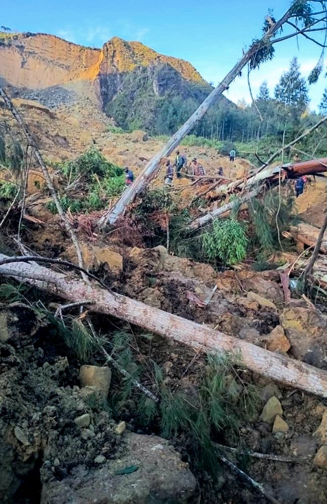 People gather at the site of a landslide in Maip Mulitaka in Papua New Guinea's Enga Province after the landslide. Picture: AFP