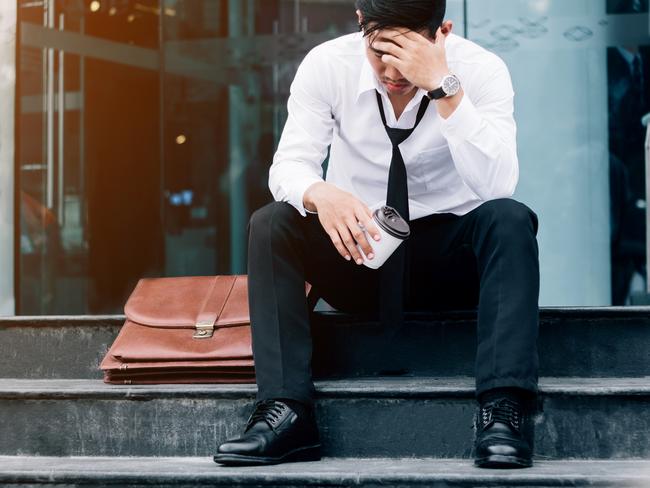 Unemployed Tired or stressed businessman sitting on the walkway after work Stressed businessman concept