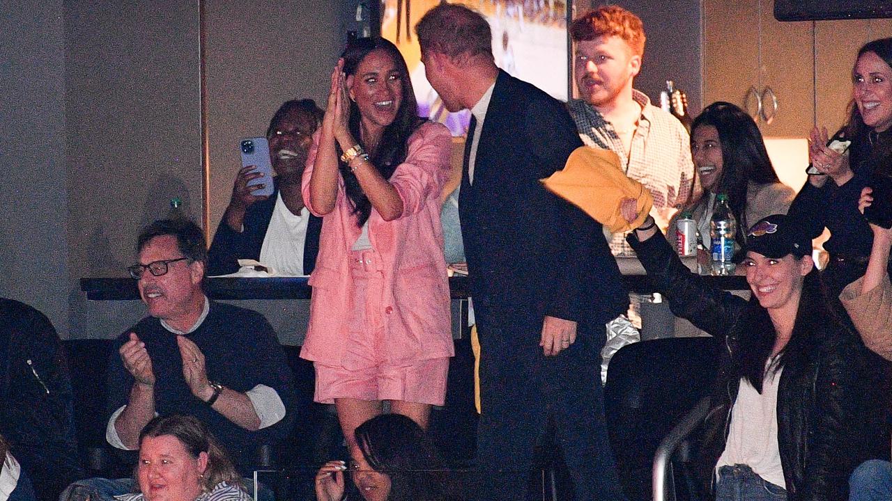 Prince Harry and Meghan Markle having fun at a basketball game. Picture: Allen Berezovsky/Getty Images