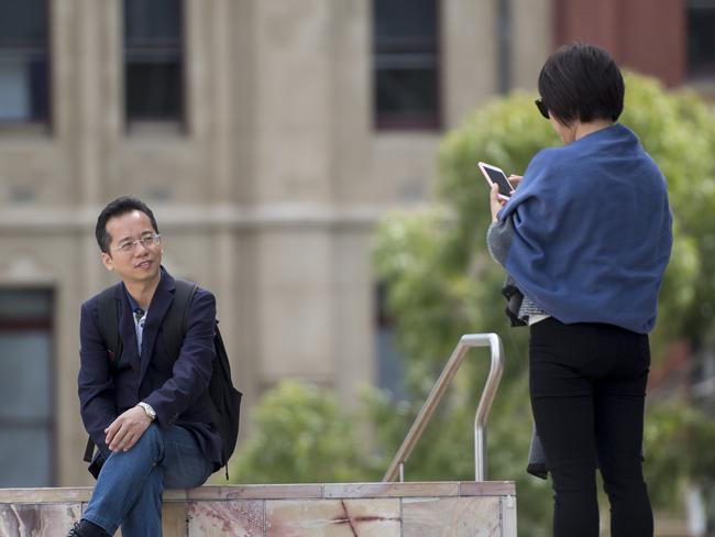 A Chinese tourist posing at Federation Square. Picture: Jason Edwards