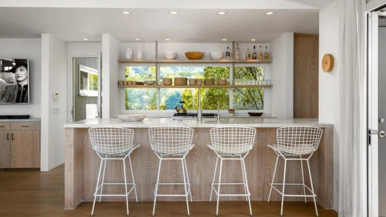 The kitchen has open shelving and counter seating. Picture: Realtor/Berkshire Hathaway