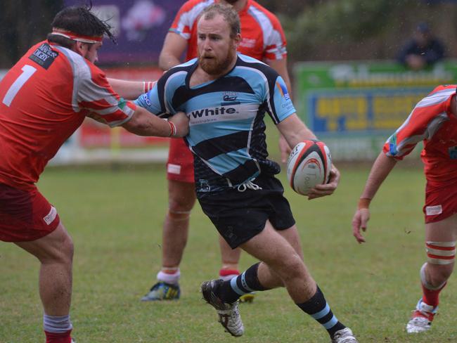 Maroochydore Swans reserve grade coach Pat O’Hare wrestles with a defender. Picture: John McCutcheon / Sunshine Coast Daily