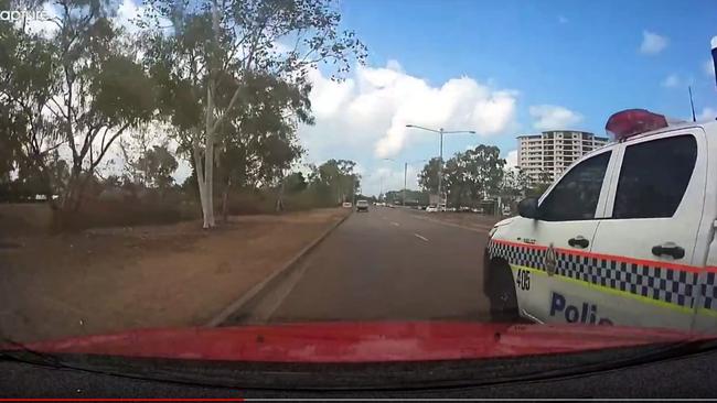 A cop car has narrowly avoided colliding with a Darwin motorist on the Stuart Hwy. Video: Brett Perry