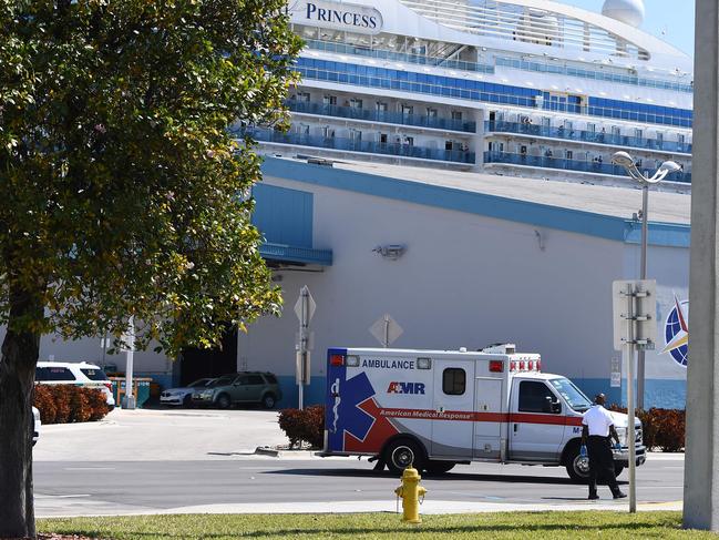 An ambulance takes a patient from the cruise ship Coral Princess to hospital. Picture: AFP.