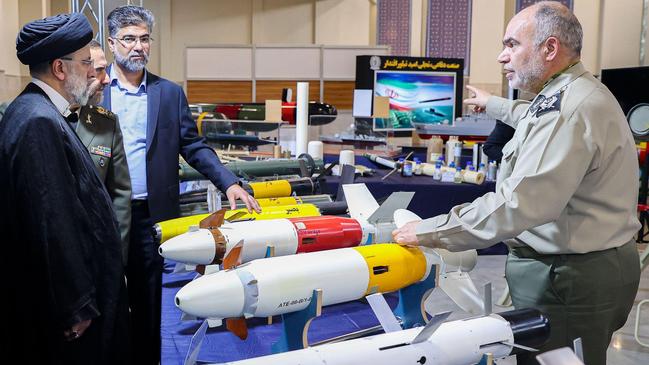 Iranian President Ebrahim Raisi (L) examines drones resembling America's armed MQ-9 Reaper, and guided missiles. Picture: Iranian Presidency via Alamy.