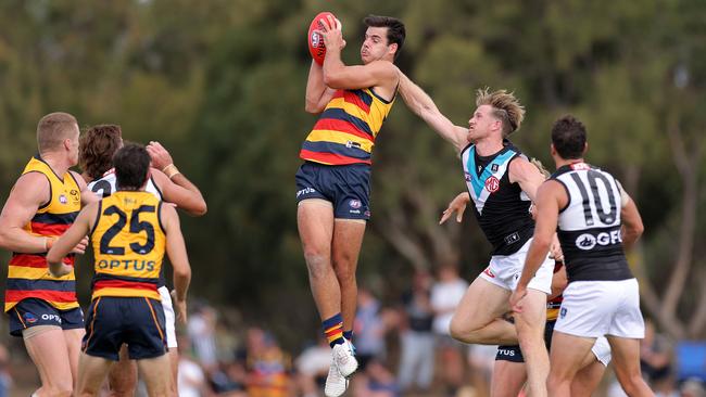 Darcy Fogarty marks in front of Port Adelaide skipper Tom Jonas in the AAMI Series. Picture: Daniel Kalisz/Getty Images