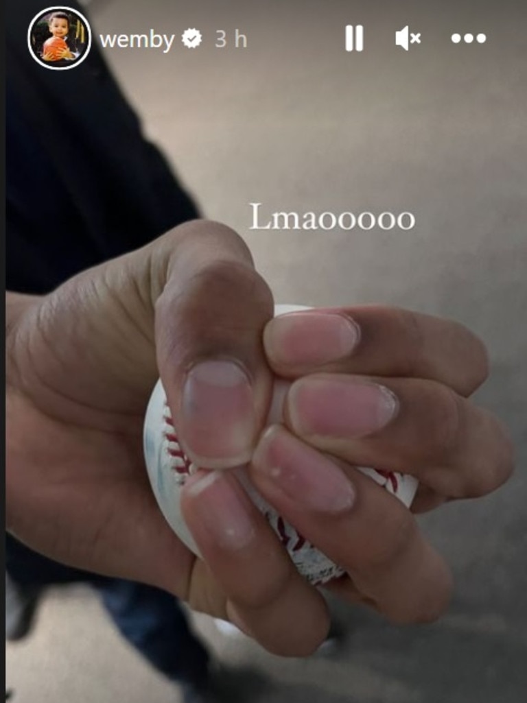 Victor Wembanyama holding a baseball