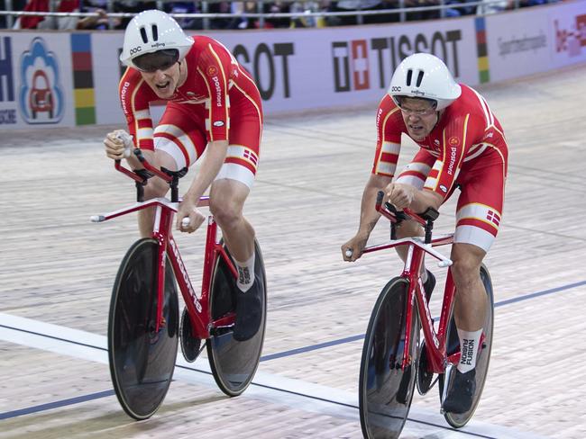 Frederik Madsen from Denmark, from left, crosses the finish line with his team mates Lasse Hansen and Julius Johansen, winning the gold medal in the men's final at the Cycling World Championships in Berlin, Thursday, Feb. 27, 2020. (Sebastian Gollnow/dpa via AP)