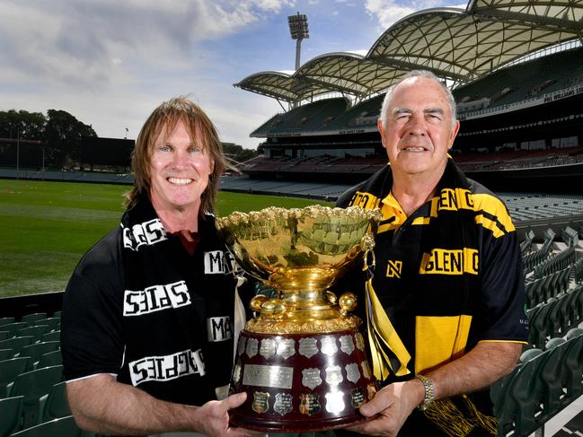 Former Port Adelaide football player Greg Anderson and former Glenelg football player Peter Carey at Adelaide Oval with the Grand Final trophy on Thursday 19 September, 2019. They are cup ambassadors for the SANFL Grand Final. (AAP Image/Sam Wundke)