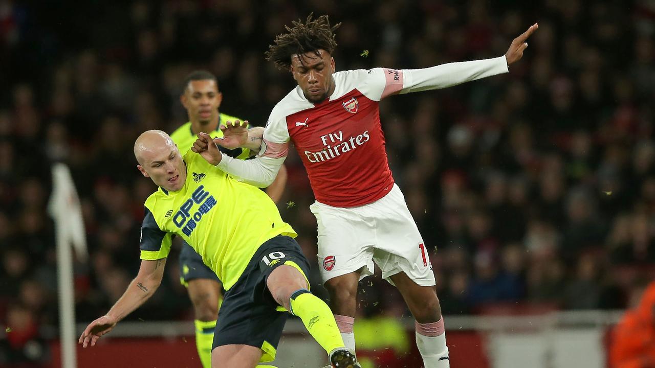Arsenal's Nigerian striker Alex Iwobi (R) vies with Huddersfield Town's Australian midfielder Aaron Mooy (L)