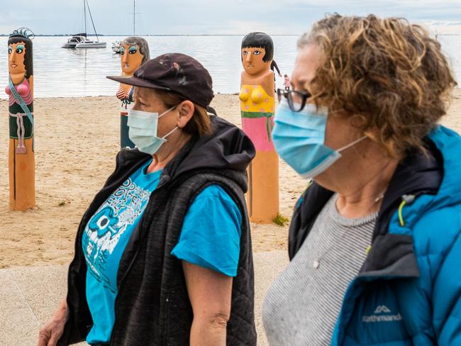 GEELONG, AUSTRALIA - AUGUST 14: People are seen walking wearing face-masks along the Geelong Waterfront on August 14, 2020 in Geelong, Australia. Metropolitan Melbourne is under stage 4 lockdown restrictions, with people only allowed to leave home to give or receive care, shopping for food and essential items, daily exercise and work while an overnight curfew from 8pm to 5am is also in place. The majority of retail businesses are also closed. Other Victorian regions are in stage 3 lockdown. The restrictions, which came into effect from 2 August, have been introduced by the Victorian government as health authorities work to reduce community COVID-19 transmissions across the state. (Photo by Asanka Ratnayake/Getty Images)