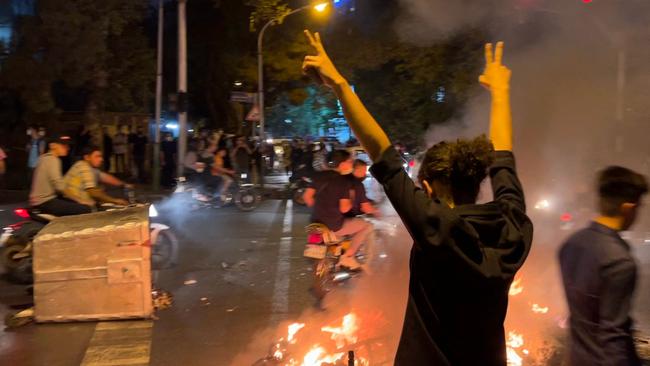 A demonstrator raises his arms and makes the victory sign during a protest for Mahsa Amini, a woman who reportedly died after being arrested by the Islamic republic's ‘morality police’. Picture: AFP