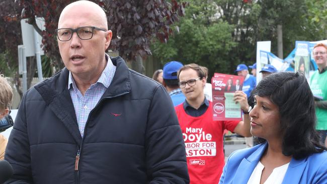 Mary Doyle supporter Aidan Smith behind the Liberals press conference. Picture: David Crosling