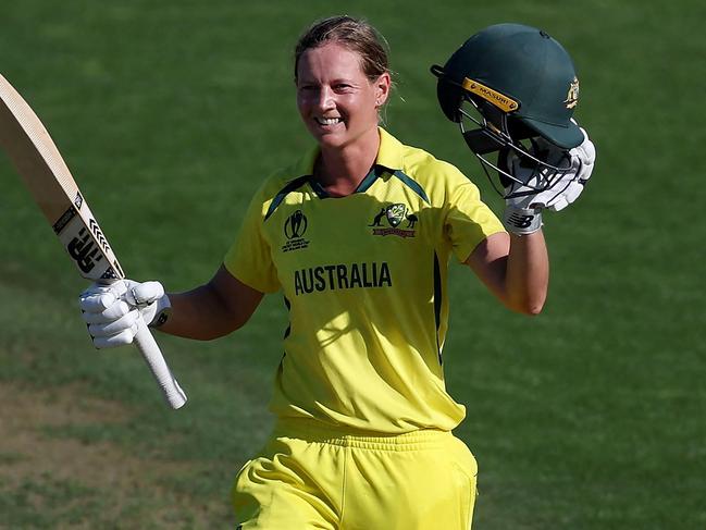 (FILES) In this file photo taken on March 22, 2022 Australia's captain Meg Lanning celebrates after reaching her century (100 runs) during the Women's Cricket World Cup match between Australia and South Africa at the Basin Reserve in Wellington on March 22, 2022. - Waiting tables in her local cafe and hanging out with friends and family helped rekindle Meg Lanning's love of cricket and intensified her drive to steer top-ranked Australia to another Twenty20 World Cup title this month.The decorated women's skipper took a indefinite months-long hiatus in 2022 after an intense few years, sparking fears she would not return. (Photo by Marty MELVILLE / AFP)