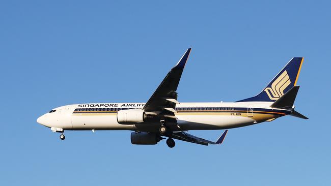 A Singapore Airlines passenger jet plane flies into the Cairns International Airport. Picture: Brendan Radke