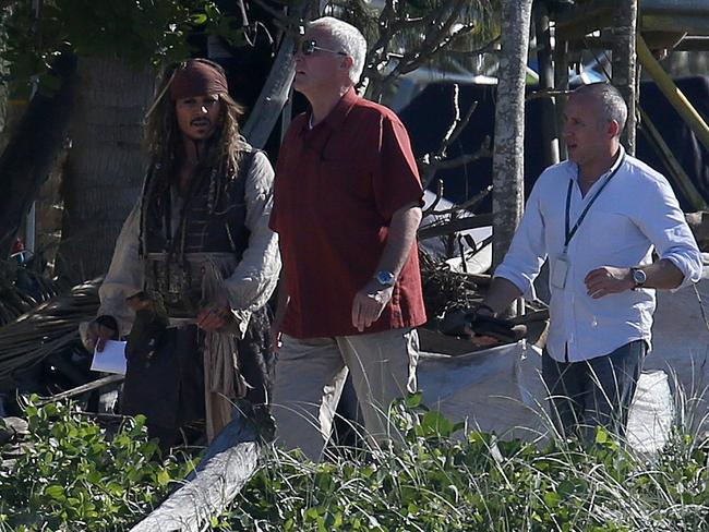 Hollywood superstar Johnny Depp, surrounded by bodyguards, walks to the Pirates of the Caribbean set at the Doug Jennings Park on The Spit in Broadwater, Gold Coast. Picture: Regi Varghese