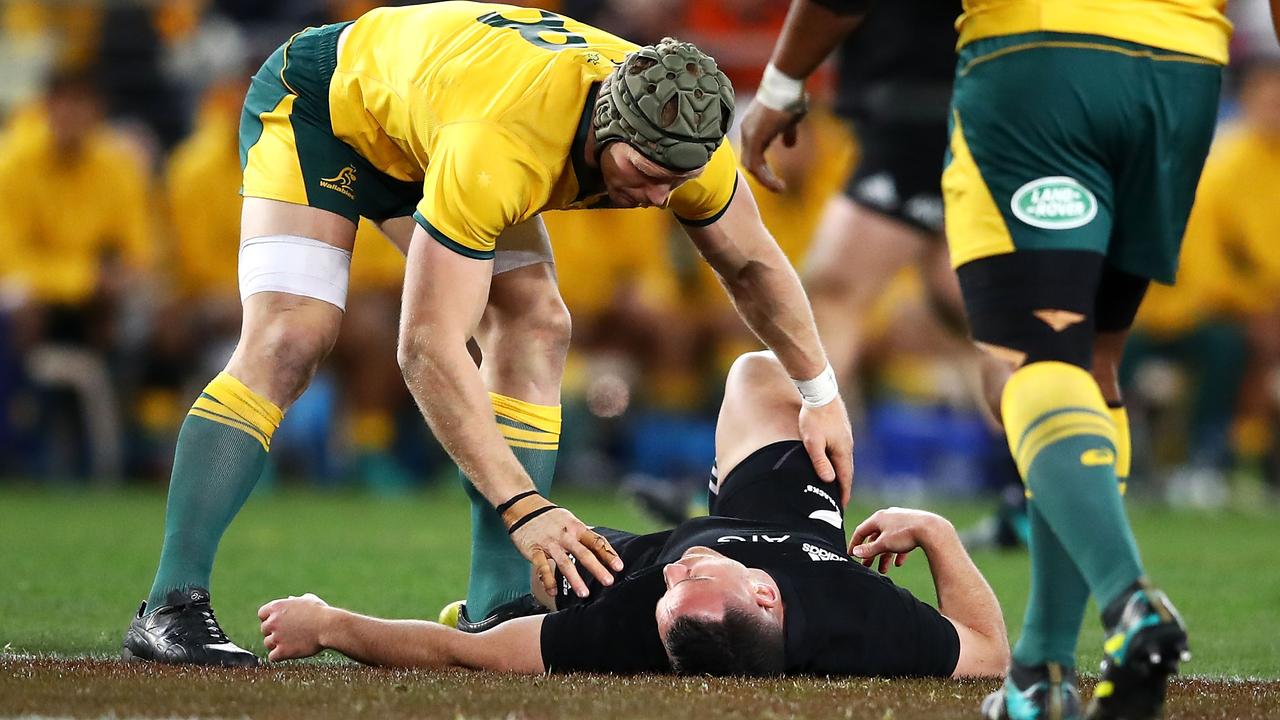 David Pocock of the Wallabies checks on concussed All Black Ryan Crotty.