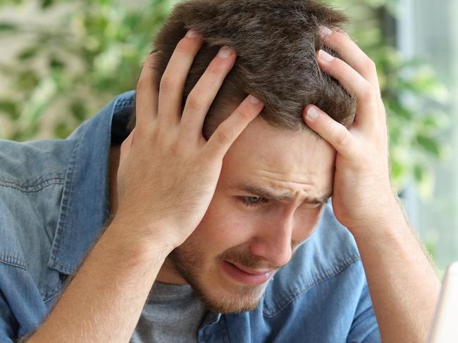 A stressed man at his computer after just realising he has been scammed. Picture: iStock.