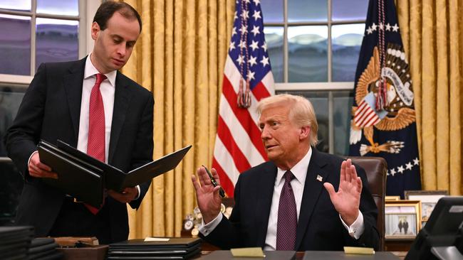 President Donald Trump speaks to journalists as he signs executive orders. Picture: AFP