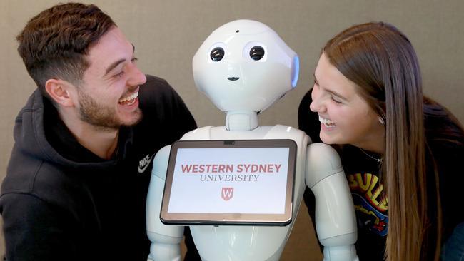 WSU students Lucas Lombardo and Sandra Gorgeuska with Pepper the robot. Picture: AAP IMAGE / Angelo Velardo