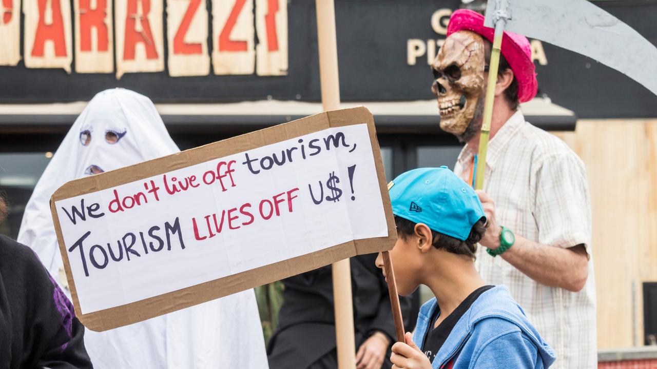 A young boy carries a placard as local people in the capital of Gran Canaria, Las Palmas, protest against the gentrification of local neighbourhoods in the city, which, they say, is leading to rising rental costs for local people. Picture: Alan Dawson/Alamy