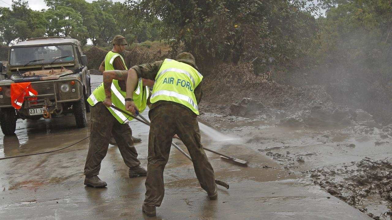 Royal Australian Air Force Members cleaning up the Goodna Freedom Xpress Super Mart service station after the Queensland floods left its affect on the area.