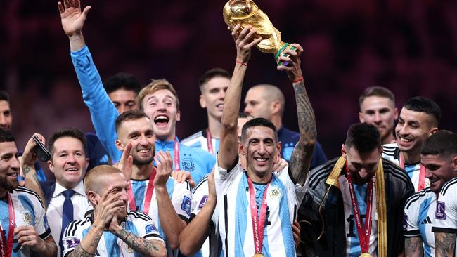 Angel Di Maria holds the World Cup trophy aloft.