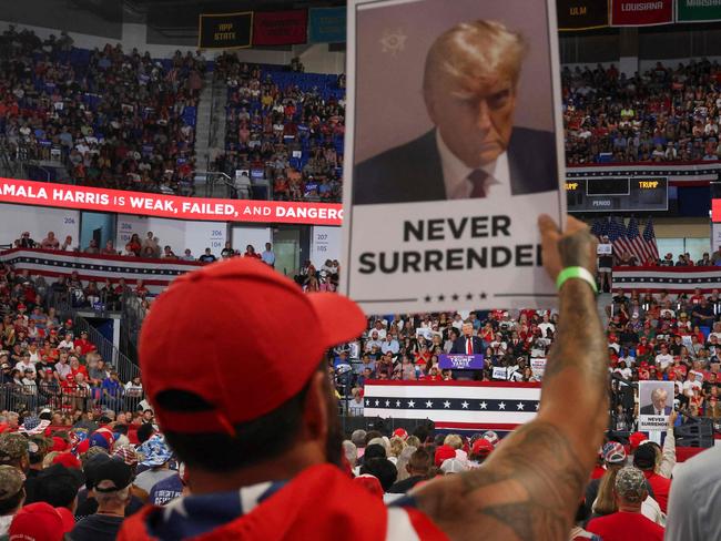 A supporter holds a “Never Surrender” sign at the rally. Picture: AFP