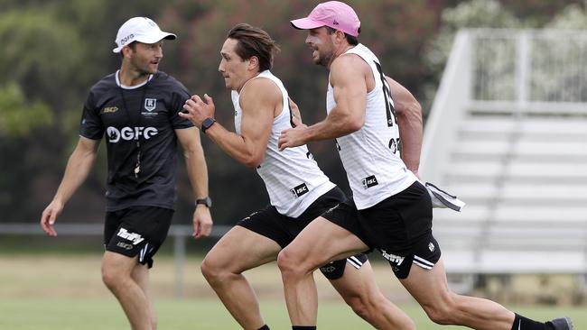 Tobin Cox (middle) works hard on his running alongside veteran teammate Travis Boak during Port Adelaide’s pre-season training camp at Maroochydore. Picture: Sarah Reed.