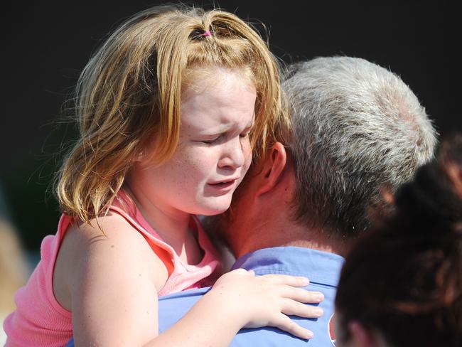 Lilly Chapman, eight, cries after being reunited with her father, John Chapman at Oakdale Baptist Church  in Townville.