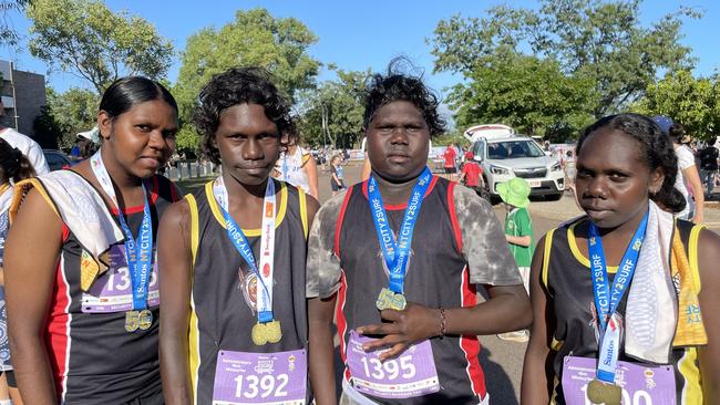 (L-R) Lindy Olsen, Reggie Tipungwuti, Matthew Puruntatameri and Winnie Puruntatameri, from the Tiwi Islands, all competed in the NT City2Surf 4km Administrator's Minisurfer on Sunday.