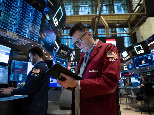 Traders work on the floor of the New York Stock Exchange (NYSE) during morning trading on January 3, 2024, in New York City. Wall Street stocks slumped to start Wednesday with all three major US indices in the red and key names such as Facebook parent Meta Platforms and Nvidia falling. (Photo by ANGELA WEISS / AFP)