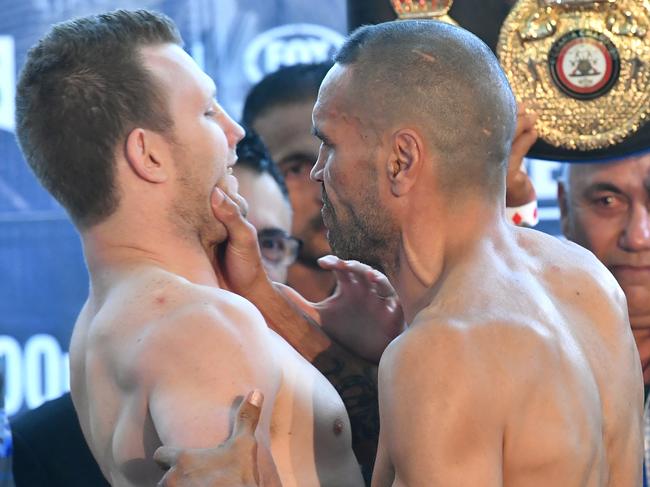 Anthony Mundine grabs Jeff Horn during their weigh-in in Brisbane on Thursday.  Picture: AAP