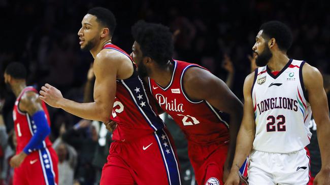 Joel Embiid congratulates Ben Simmons after nailing his first three-point shot. Picture: AP