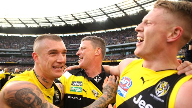 Josh Caddy (right) celebrates Richmond’s premiership with Dustin Martin and Damien Hardwick.