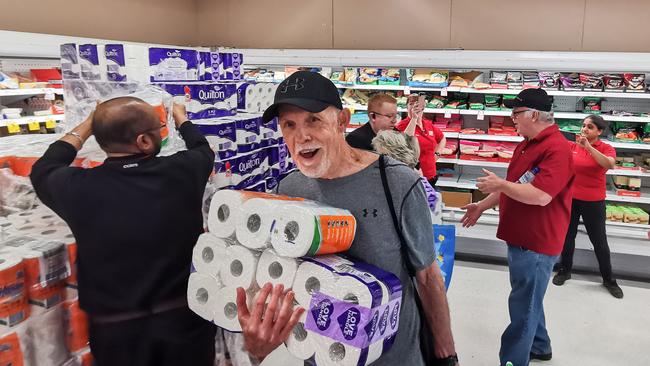 People receiving toilet paper, paper towels and pasta at Coles in Epping in Sydney on Friday. Supermarkets have imposed limits to control panic-buying. Picture: AAP