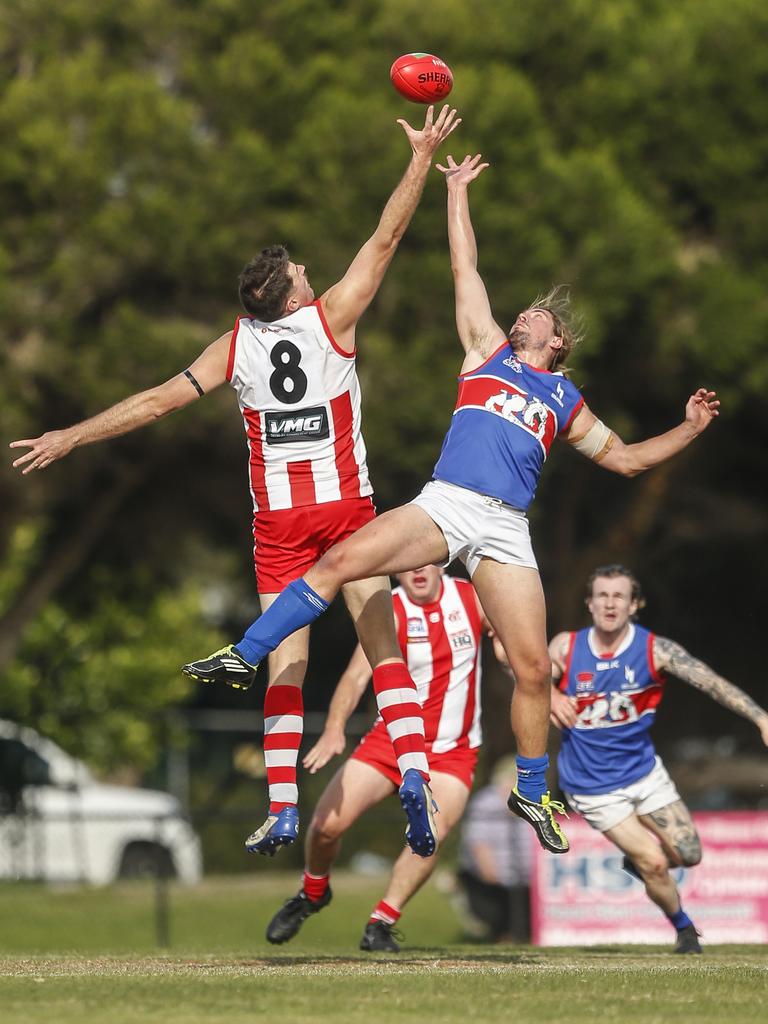 Southern: Mordialloc’s Matthew Devine wins the tap over Remy Cadman of St Paul’s. Picture: Valeriu Campan