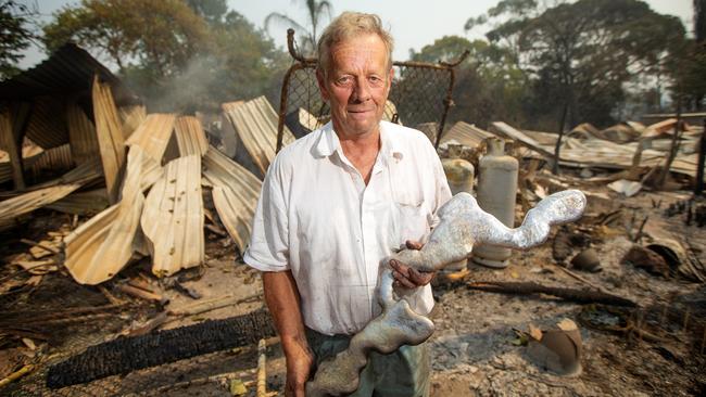 Rex Newton, 69, holds the remains of the roof of his Bunyip North home of 40 years. Picture: Mark Stewart