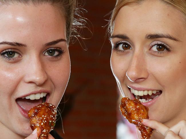 Indy Odell, 21, Hawthorne, & Melissa Forsyth, 21, Chelmer, enjoying Chur Burger's Korean style chicken wings, Fortitude Valley Brisbane. The wings have made the Courier Mail Top 10 list. Photographer: Liam Kidston.