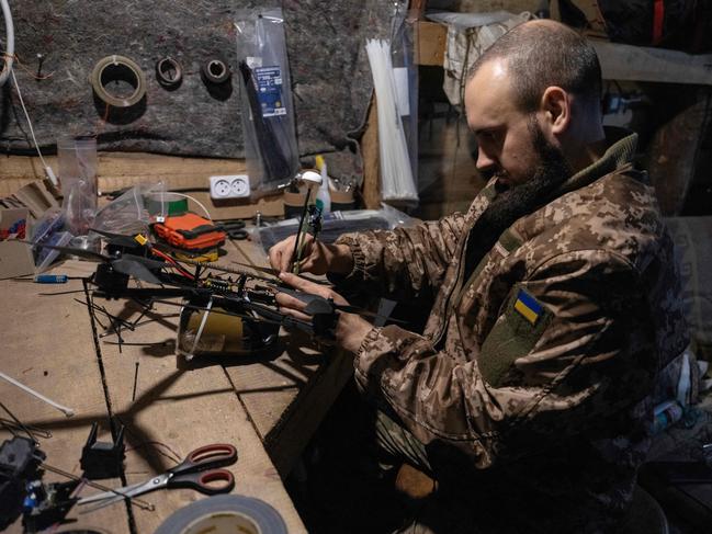 A Ukrainian serviceman prepares an FPV drone prior to it being launched towards Russian positions in the Donetsk region. Picture: AFP