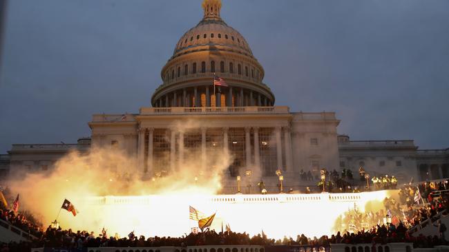 An explosion caused by a police munition is seen while supporters of US President Donald Trump gather in front of the Capitol building. Picture: Leah Mills/Reuters