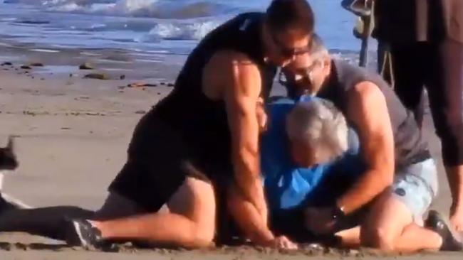 Peter Foster is crash tackled and arrested on a remote beach in Queensland. Picture: Channel 9