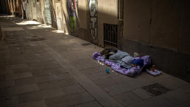 A woman sleeps on the ground in Barcelona on June 5. Picture: AP Photo/Emilio Morenatti