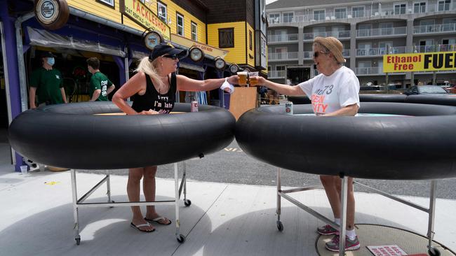 Restaurant guests try social-distancing devices as Fish Tails bar and grill in Ocean City, Maryland. Picture: AFP