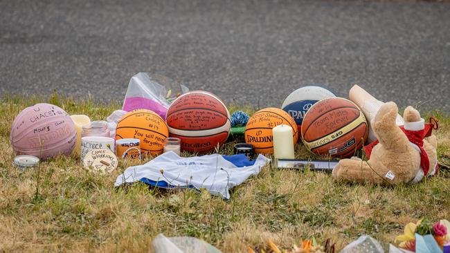 Tributes included basketballs and other items popular with the victims. Picture: Jason Edwards