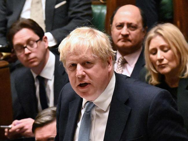 A handout photograph released by the UK Parliament shows Former Prime Minister Theresa May (top R) listening alongside fellow Conservative MPs as Britain's Prime Minister Boris Johnson speaking during a statement following an update on a report by Sue Gray in to parties at Downing Street during Covid-19 lockdowns, in the House of Commons in London on January 31, 2022. - British Prime Minister Boris Johnson on Monday apologised after his government was criticised for "failures of leadership and judgment" in allowing lockdown-breaching parties at his offices. Johnson's position has been hanging by a thread because of the steady drip of revelations since late last year, but he has in the last week been given a lifeline as police stepped in. (Photo by JESSICA TAYLOR / various sources / AFP) / RESTRICTED TO EDITORIAL USE - NO USE FOR ENTERTAINMENT, SATIRICAL, ADVERTISING PURPOSES - MANDATORY CREDIT " AFP PHOTO / Jessica Taylor /UK Parliament"